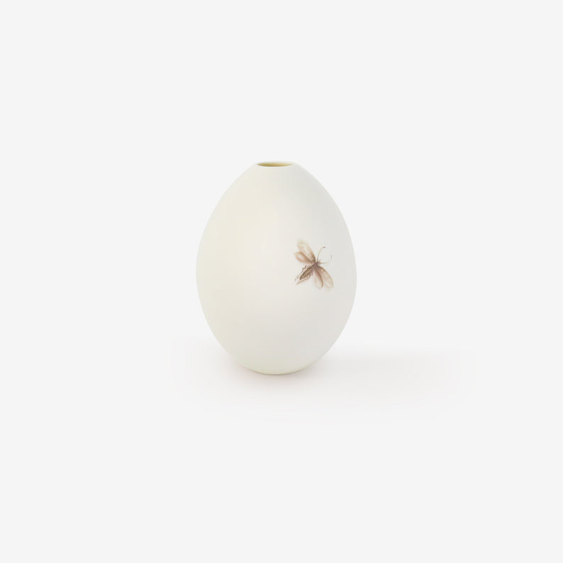 TED MUEHLING SMALL WHITE BISQUE GOOSE EGG VASE WITH PAINTED MOTH