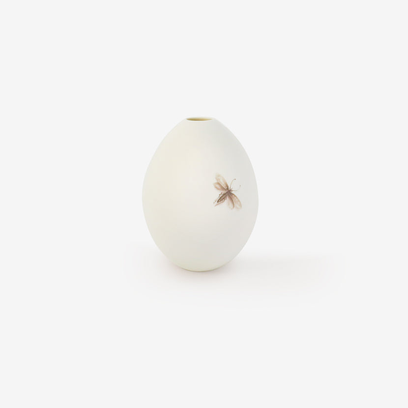 TED MUEHLING SMALL WHITE BISQUE GOOSE EGG VASE WITH PAINTED MOTH