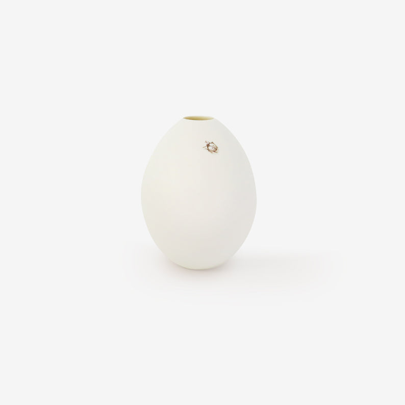 TED MUEHLING SMALL WHITE BISQUE GOOSE EGG VASE WITH PAINTED SMALL LADYBUG